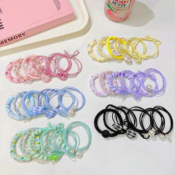 Display of six pastel floral hair ties in a set, featuring various soft color tones for versatile, cute hair accessories 