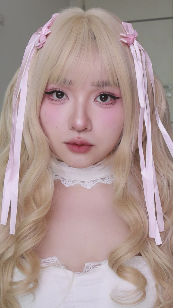Model trying Aura Bloom Rose Quartz Colored Contacts Lenses
