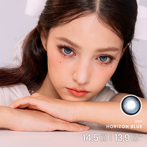 Model wearing Horizon Blue Contacts with a cool-toned, luminous blue-eye look