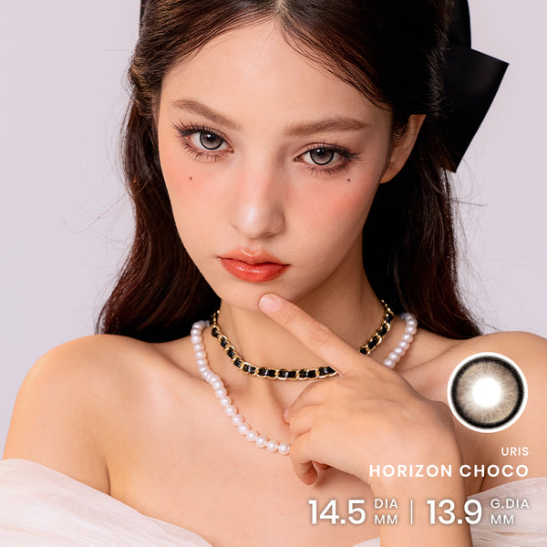 Model wearing Horizon Choco Colored Contacts with a glossy brown-eye look