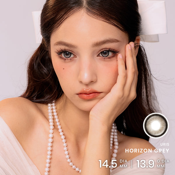Model wearing Horizon Grey Contacts with a cool-toned, luminous grey-eye look